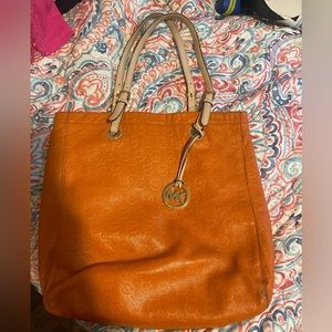 Michael Kors Large Orange Pebbled Leather
Purse Logo Imprint Tote
